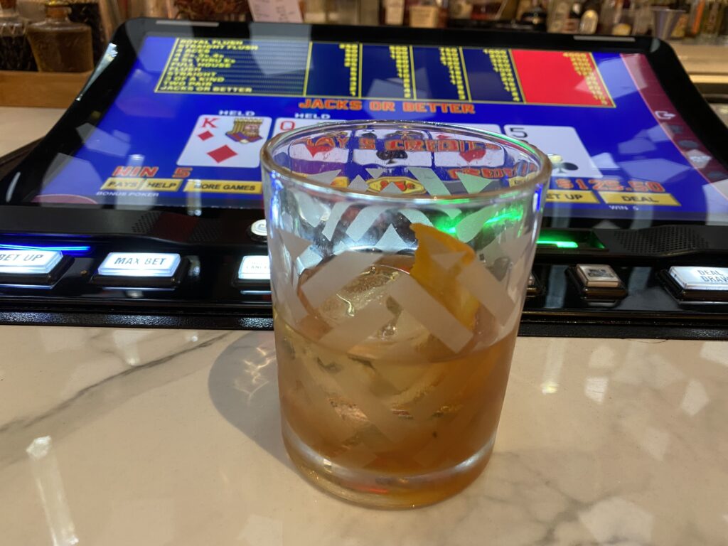 Old fashioned cocktail on a marble bar.