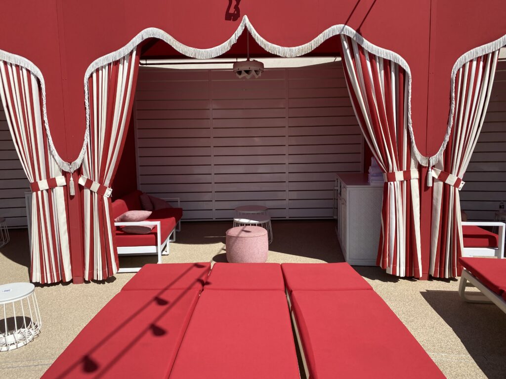 Cabana with a red canopy and couch.