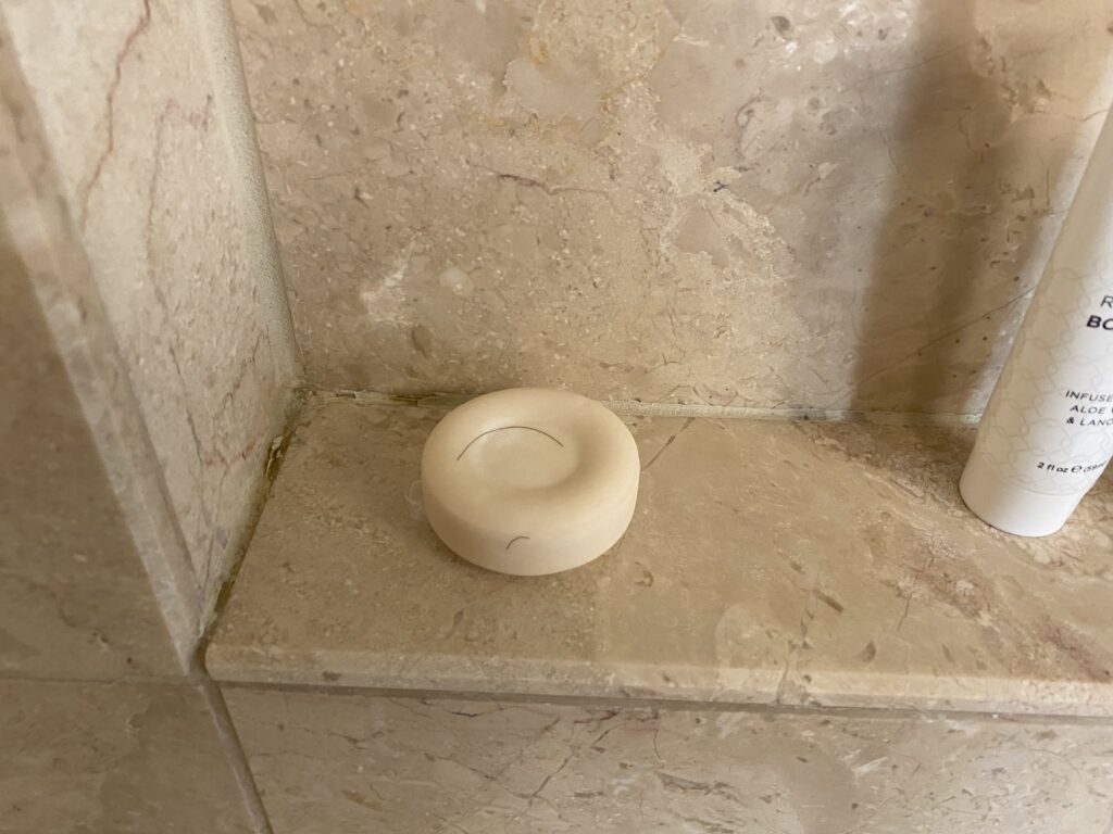 Circular soap with hair on it. 
