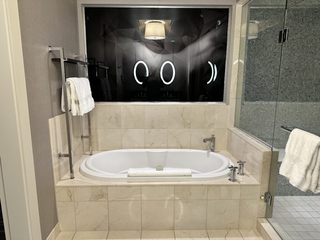 Cosmo bathtub, white tub with taupe tiles. 
